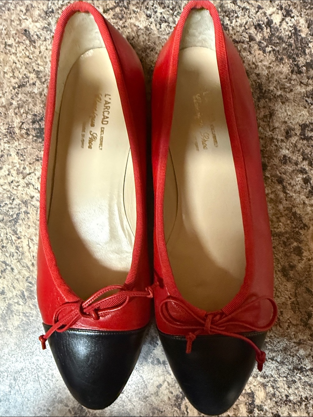 Red Leather Ballet Flats with Black Cap Toe and Bow Accent